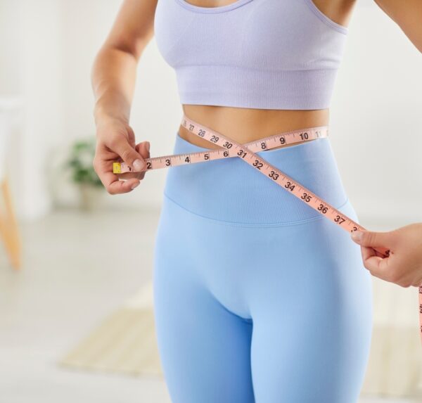 Close,Up,Slim,Sporty,Fit,Woman,Measuring,Waist,Line,With