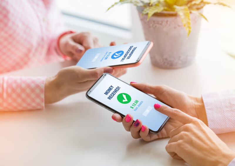 Woman,Sending,Money,To,Her,Friend,Using,Mobile,Phone