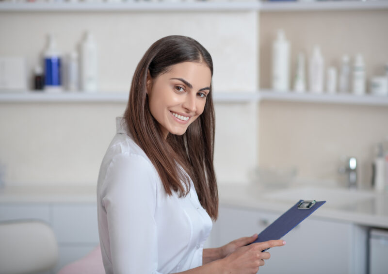 Cosmetologist.,Pretty,Young,Professional,Standing,In,The,Room,And,Looking